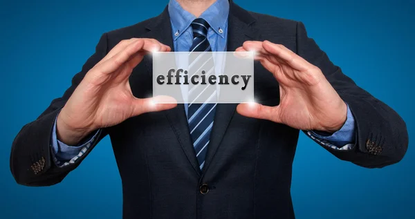 Businessman holds efficiency sing in his hands - Stock Image — Stock Photo, Image