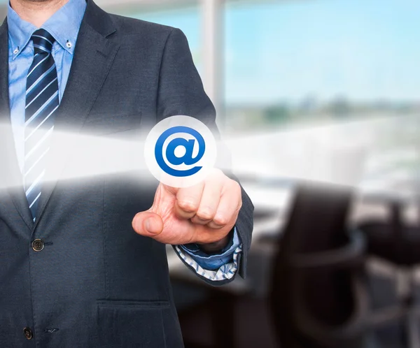Businessman pressing mail button on visual screen. Customer support concept. Stock Image — Stock Photo, Image