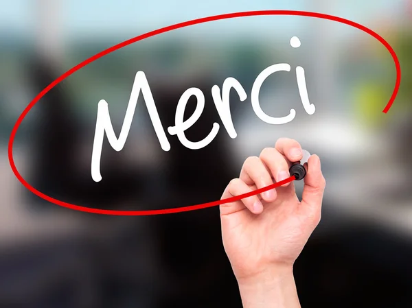 Uomo Scrittura a mano Merci (Thank You In French) con pennarello nero — Foto Stock