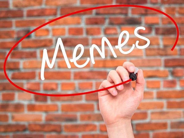 Man Hand writing Memes with black marker on visual screen. — Stock Photo, Image