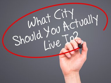 Man Hand writing What City Should You Actually Live In? with bla