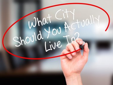 Man Hand writing What City Should You Actually Live In? with bla