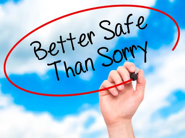 Man Hand writing Better Safe Than Sorry with black marker on vis — Stock Photo, Image