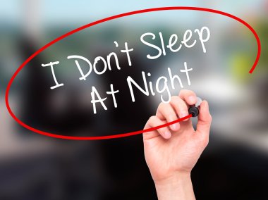 Man Hand writing I Don't Sleep At Night with black marker on vis