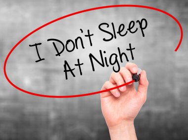 Man Hand writing I Don't Sleep At Night with black marker on vis