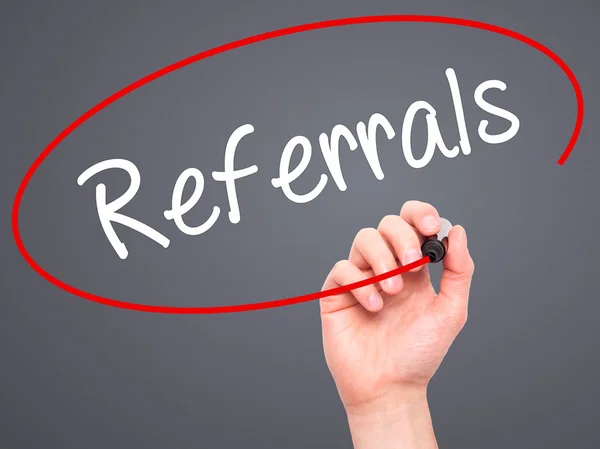 Man Hand writing Referrals with black marker on visual screen. — Stock Photo, Image