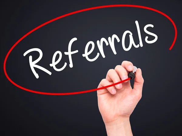 Man Hand writing Referrals with black marker on visual screen. — Stock Photo, Image