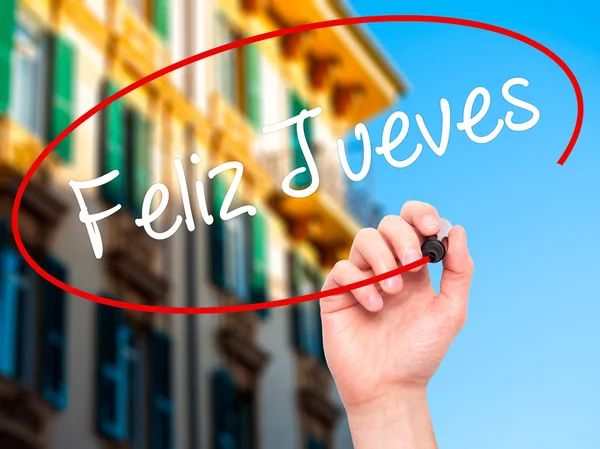Человек, написавший Feliz Jueves ("Счастливый четверг" на испанском языке) с б — стоковое фото