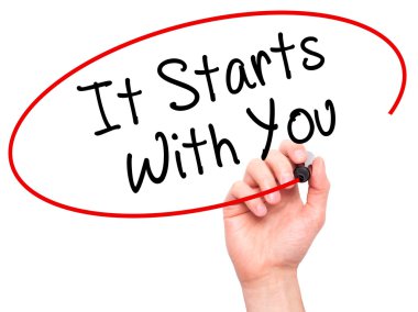Man Hand writing It Starts With You with black marker on visual 