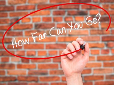 Man Hand writing  How Far Can You Go? with black marker on visua
