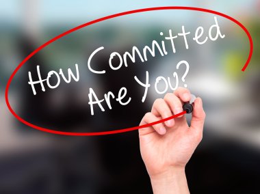 Man Hand writing How Committed Are You? with black marker on vis