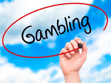 Man Hand writing Gambling  with black marker on visual screen