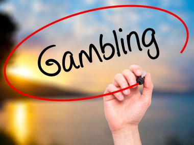 Man Hand writing Gambling  with black marker on visual screen