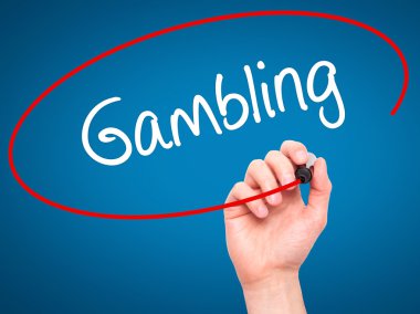 Man Hand writing Gambling  with black marker on visual screen