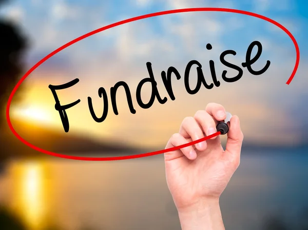 Man Hand writing Fundraise with black marker on visual screen — Stock Photo, Image