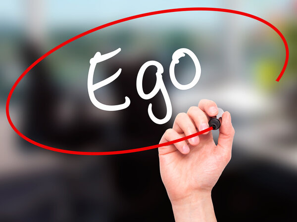 Man Hand writing Ego with black marker on visual screen