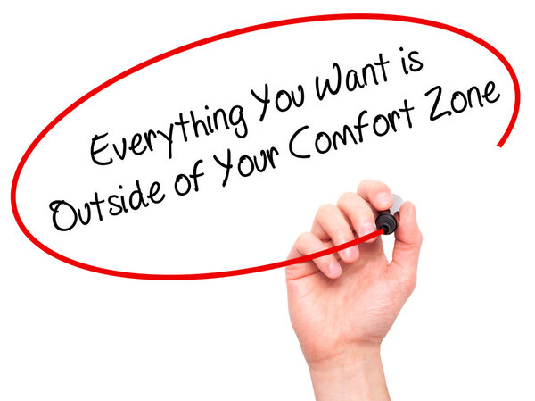 Man Hand writing Everything You Want is Outside of Your Comfort 