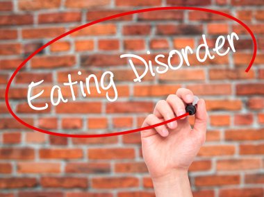 Man Hand writing Eating Disorder  with black marker on visual sc clipart