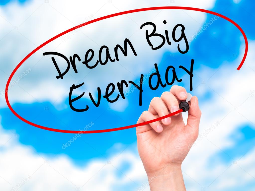 Man Hand writing Dream Big Everyday with black marker on visual 