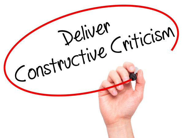 Man Hand writing Deliver Constructive Criticism with black marke