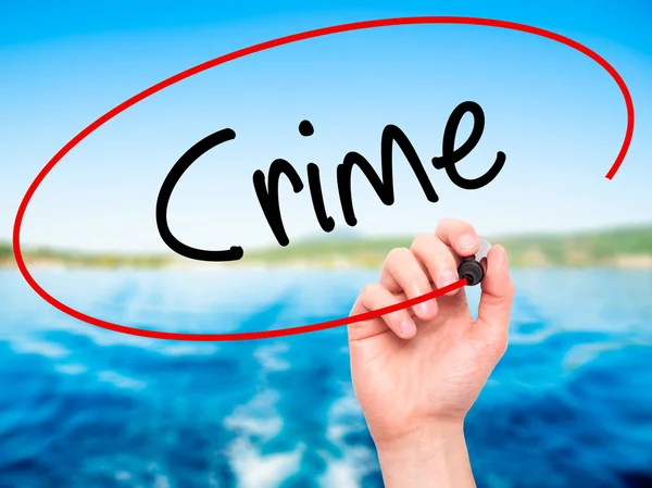 Man Hand writing Crime with black marker on visual screen — Stock Photo, Image