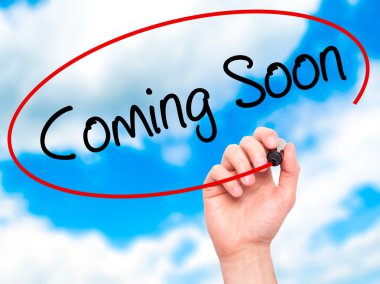 Adam el Coming Soon görsel ekranda siyah kalemi ile yazma
