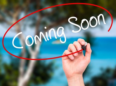 Adam el Coming Soon görsel ekranda siyah kalemi ile yazma