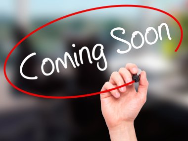 Adam el Coming Soon görsel ekranda siyah kalemi ile yazma