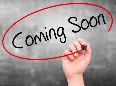 Adam el Coming Soon görsel ekranda siyah kalemi ile yazma