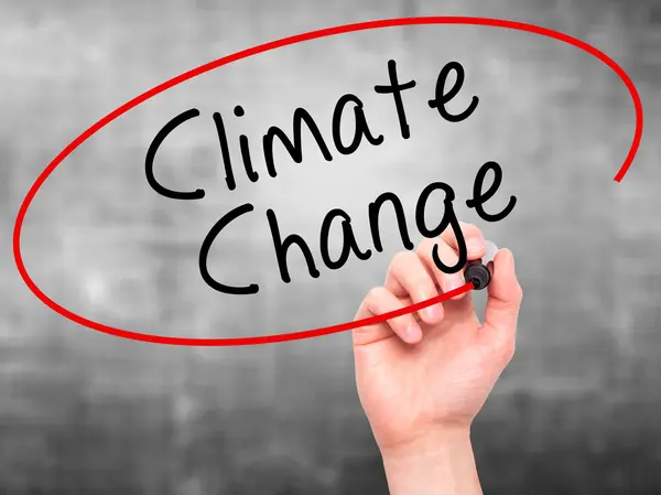 Man Hand writing Climate Change with black marker on visual scre — Stockfoto
