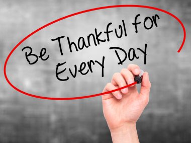 Man Hand writing Be Thankful for Every Day   with black marker o clipart