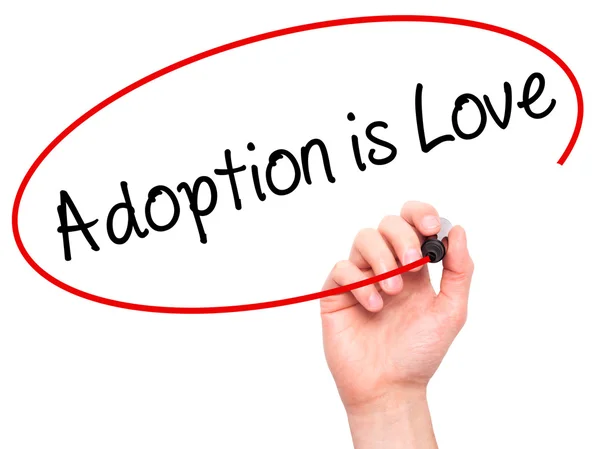 Man Hand writing Adoption is Love with black marker on visual sc — Stock Photo, Image