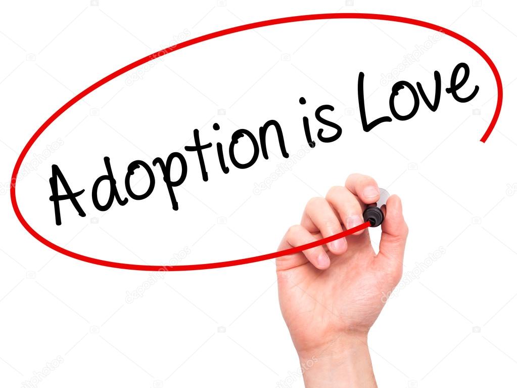 Man Hand writing Adoption is Love with black marker on visual sc