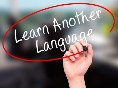 Man Hand writing Learn Another Language with black marker on vis