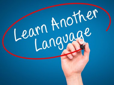 Man Hand writing Learn Another Language with black marker on vis