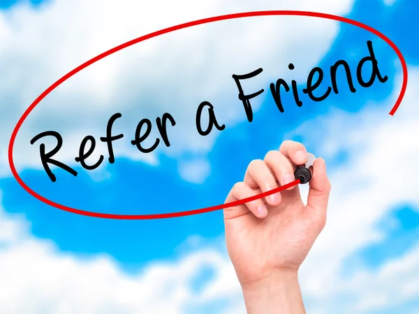 Man Hand writing Refer a Friend  with black marker on visual scr — Stock Photo, Image