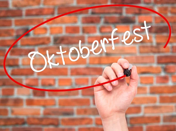 Man Hand writing Oktoberfest   with black marker on visual scree — Stock Photo, Image