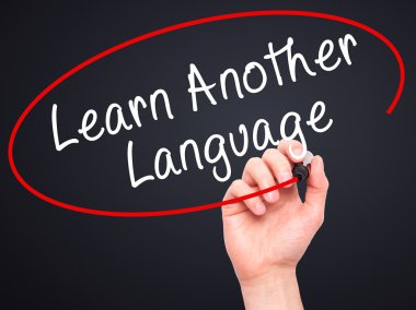 Man Hand writing Learn Another Language with black marker on vis