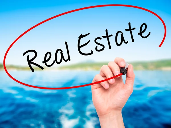 Man Hand writing Real Estate  with black marker on visual screen — Stock Photo, Image