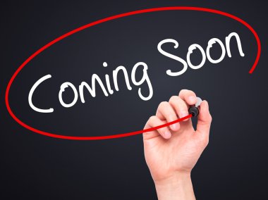 Adam el Coming Soon görsel ekranda siyah kalemi ile yazma