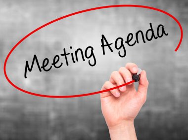 Man Hand writing Meeting Agenda  with black marker on visual scr clipart