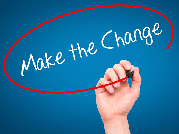 Man Hand writing Make the Change with black marker on visual scr