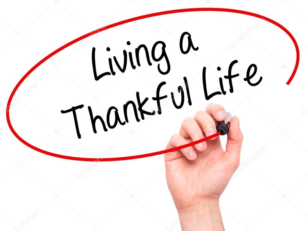 Man Hand writing Living a Thankful Life with black marker on vis