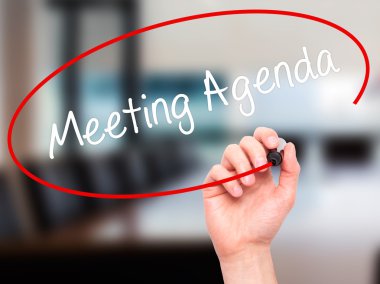Man Hand writing Meeting Agenda  with black marker on visual scr clipart