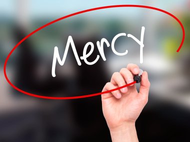 Man Hand writing Mercy with black marker on visual screen clipart