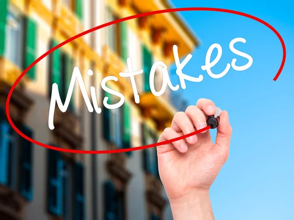 Man Hand writing  Mistakes with black marker on visual screen — Stock Photo, Image