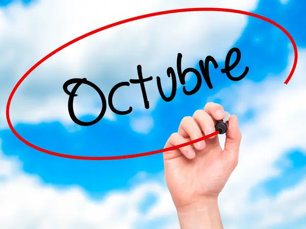 Man Hand writing &quot;Octubre&quot; (In Spanish: October) with — Stock Photo, Image