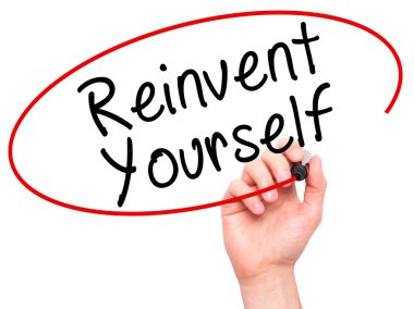 Man Hand writing Reinvent Yourself with black marker on visual s