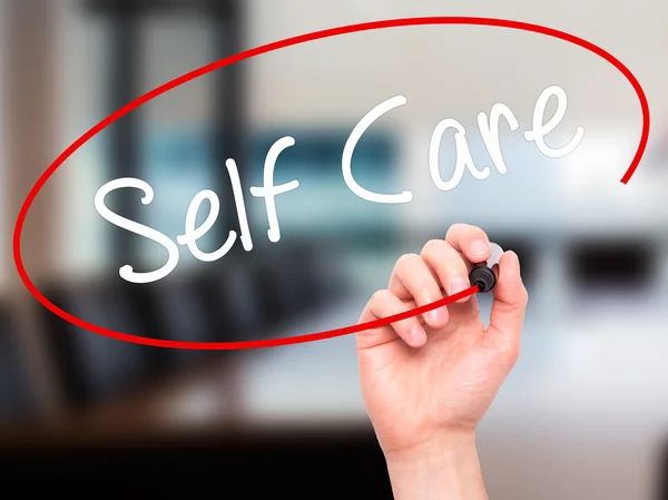 stock image Man Hand writing Self Care with black marker on visual screen