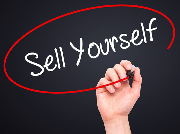 Man Hand writing Sell Yourself with black marker on visual scree